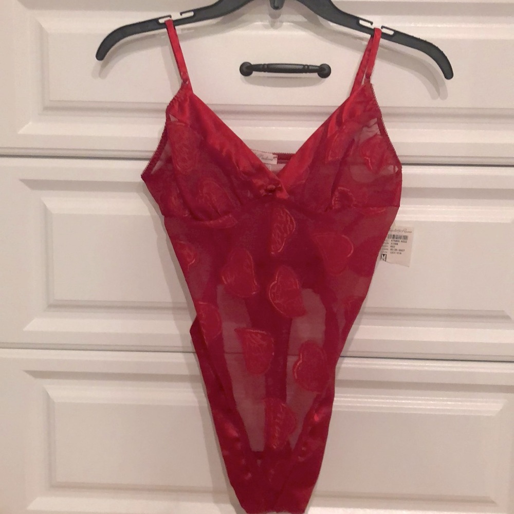 NEW. Tag on. Satin and sheer with heart design. Two button closure at bottom.
